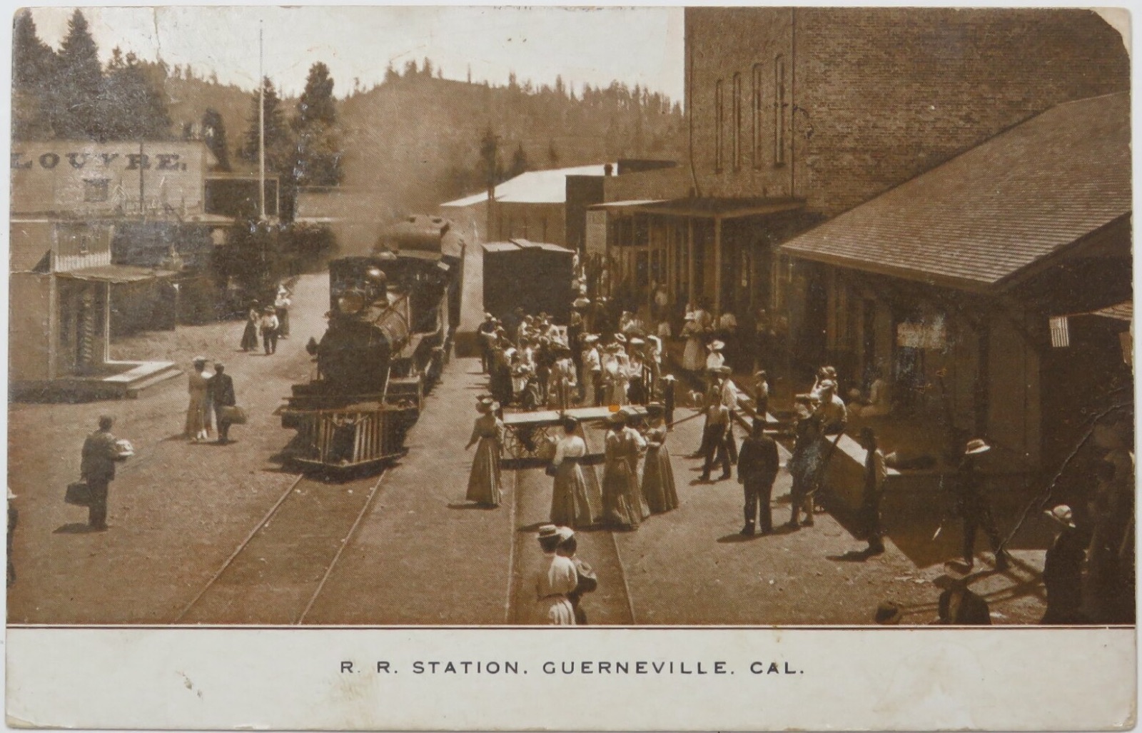 Hand-tinted postcard of the Guerneville railroad depot with passengers, postmarked 1908